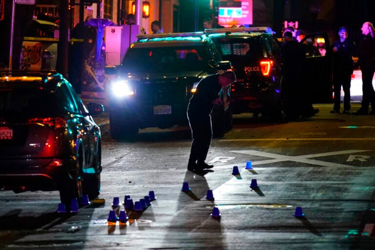 Investigators search for evidence in the area of a mass shooting in Sacramento, Calif. April 3, 2022.