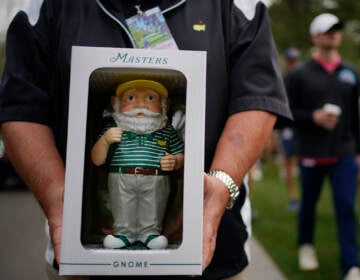 Dan Szatkowski, North Augusta, S.C, poses with his newly purchased garden gnome during a practice round for the Masters golf tournament on Tuesday, April 5, 2022, in Augusta, Ga. (AP Photo/Robert F. Bukaty)