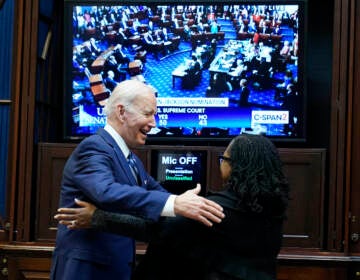 President Joe Biden goes to hug Supreme Court nominee Judge Ketanji Brown Jackson as they watch the Senate vote on her confirmation from the Roosevelt Room of the White House in Washington, Thursday, April 7, 2022. (AP Photo/Susan Walsh)