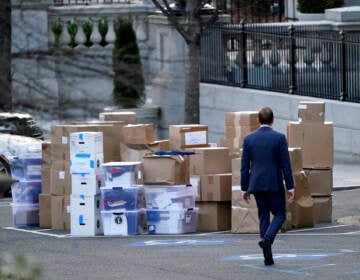 File photo: A man walks past boxes that were moved out of the Eisenhower Executive Office building, just outside the West Wing, inside the White House complex, Thursday, Jan. 14, 2021, in Washington. The State Department says it's unable to compile a complete accounting of gifts presented to U.S. officials by foreign governments during the final year of the Trump administration due to missing White House data