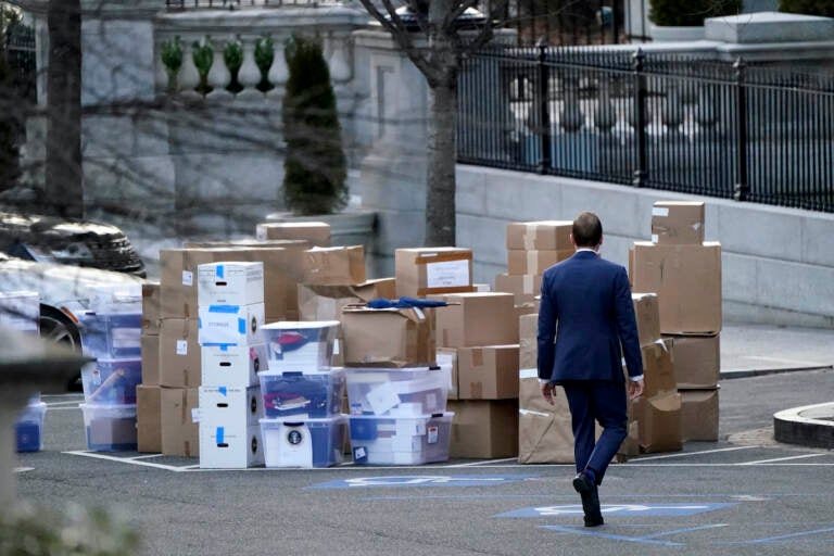 File photo: A man walks past boxes that were moved out of the Eisenhower Executive Office building, just outside the West Wing, inside the White House complex, Thursday, Jan. 14, 2021, in Washington. The State Department says it's unable to compile a complete accounting of gifts presented to U.S. officials by foreign governments during the final year of the Trump administration due to missing White House data