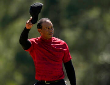 Tiger Woods tips his cap on the 18th green during the final round at the Masters golf tournament on Sunday, April 10, 2022, in Augusta, Ga.