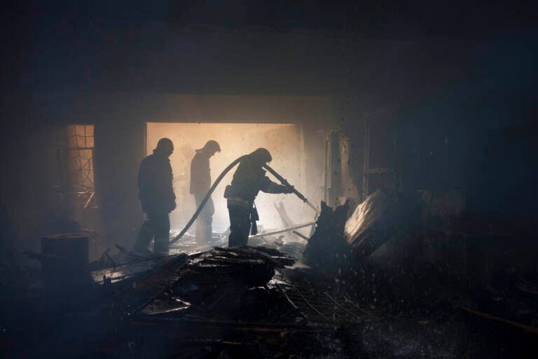 Firefighters work to extinguish a fire at a house after a Russian attack in Kharkiv, Ukraine, Monday, April 11, 2022.