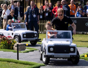 Prince Harry (right) and Meghan Markle (rear left) Duke and Duchess of Sussex, attend the Land Rover Driving Challenge at the Invictus Games venue in The Hague, Netherlands, Saturday, April 16, 2022. The week-long games for active servicemen and veterans who are ill, injured or wounded opens Saturday in this Dutch city that calls itself the global center of peace and justice