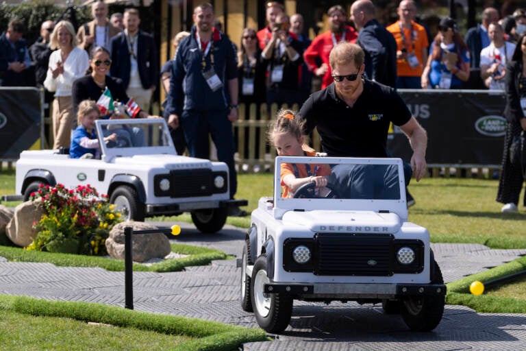 Prince Harry (right) and Meghan Markle (rear left) Duke and Duchess of Sussex, attend the Land Rover Driving Challenge at the Invictus Games venue in The Hague, Netherlands, Saturday, April 16, 2022. The week-long games for active servicemen and veterans who are ill, injured or wounded opens Saturday in this Dutch city that calls itself the global center of peace and justice