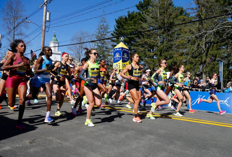 The elite women break from the starting line of the 126th Boston Marathon, Monday, April 18, 2022, in Hopkinton, Mass.