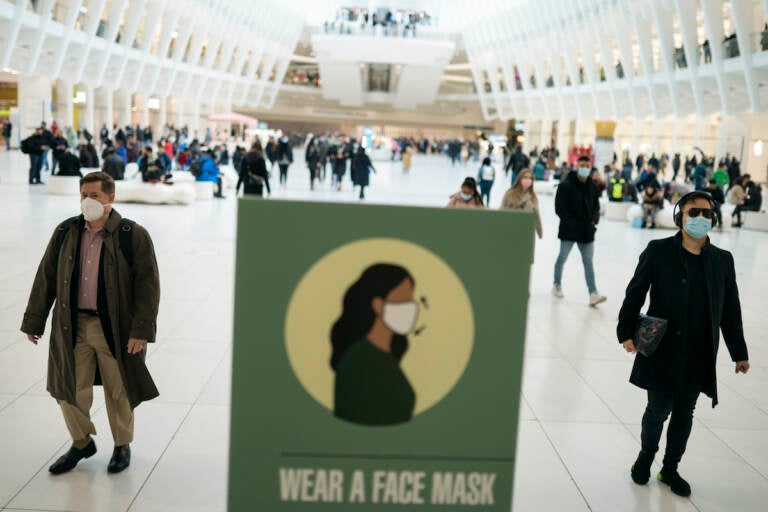 Mass transit riders wear masks as they commute in the financial district of lower Manhattan, Tuesday, April 19, 2022, in New York. U.S. District Judge Kathryn Kimball Mizelle in Tampa, Fla., on April 18, 2022, voided the national travel mask mandate as exceeding the authority of U.S. health officials. The mask mandate that covers travel on airplanes and other public transportation was recently extended by President Joe Biden's administration until May 3