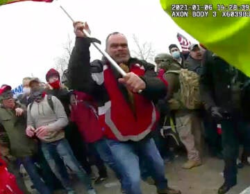 This still frame from Metropolitan Police Department body worn camera video shows Thomas Webster, in red jacket, at a barricade line at on the west front of the U.S. Capitol on Jan. 6, 2021, in Washington.