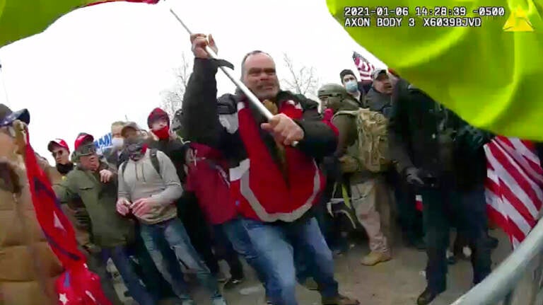 This still frame from Metropolitan Police Department body worn camera video shows Thomas Webster, in red jacket, at a barricade line at on the west front of the U.S. Capitol on Jan. 6, 2021, in Washington.