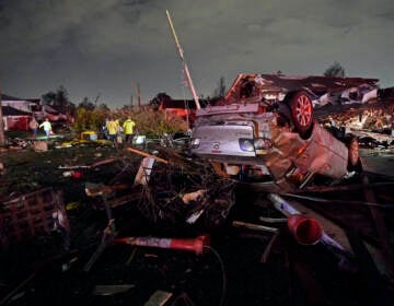 A car is flipped over after a tornado tore through the area in Arabi, La., Tuesday, March 22, 2022. A tornado tore through parts of New Orleans and its suburbs Tuesday night, ripping down power lines and scattering debris in a part of the city that had been heavily damaged by Hurricane Katrina 17 years ago. (AP Photo/Gerald Herbert)