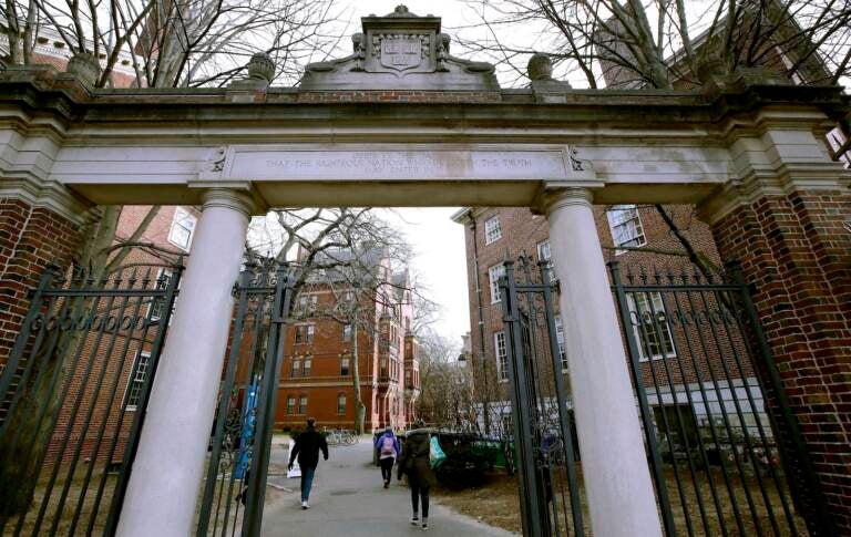 FILE - In this Dec. 13, 2018, file photo, a gate opens to the Harvard University campus in Cambridge, Mass. Harvard President Lawrence Bacow announced Tuesday, April 26, 2022 that the university is committing $100 million to study its ties to slavery and create a 