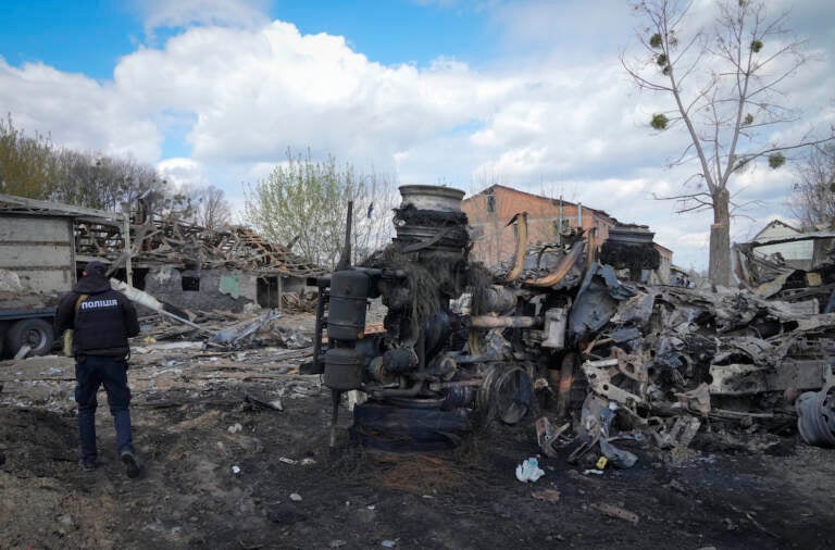 A police officer inspects a destroyed area following a Russian missiles attack on Thursday in Fastov, south of Kyiv, Ukraine, Friday, April 29, 2022. (AP Photo/Efrem Lukatsky)