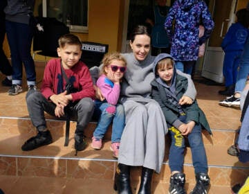 In this image provided by the Lviv city hall Angelina Jolie, Hollywood movie star and UNHCR goodwill ambassador, poses for photo with kids in Lviv, Ukraine, Saturday, Apr. 30, 2022. Ms Jolie was in Ukraine to meet the children affected by the war and visited hospitals and NGOs helping the injured and displaced