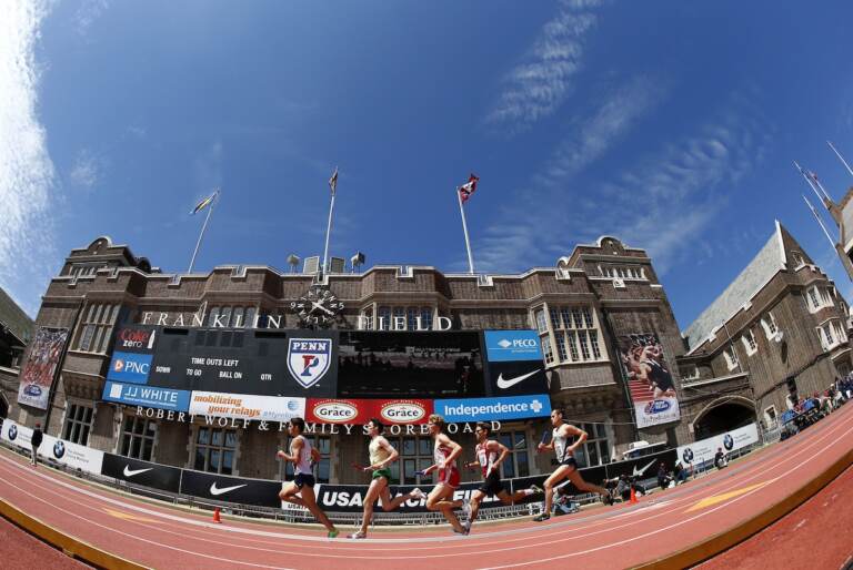 A view of runners running around a track.