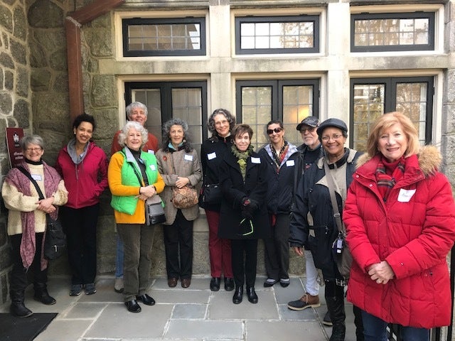 A group of ARTZ Care Partners gather together outside a building.