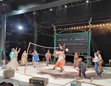 People are playing volleyball onstage in the Wilma Theater's production of 