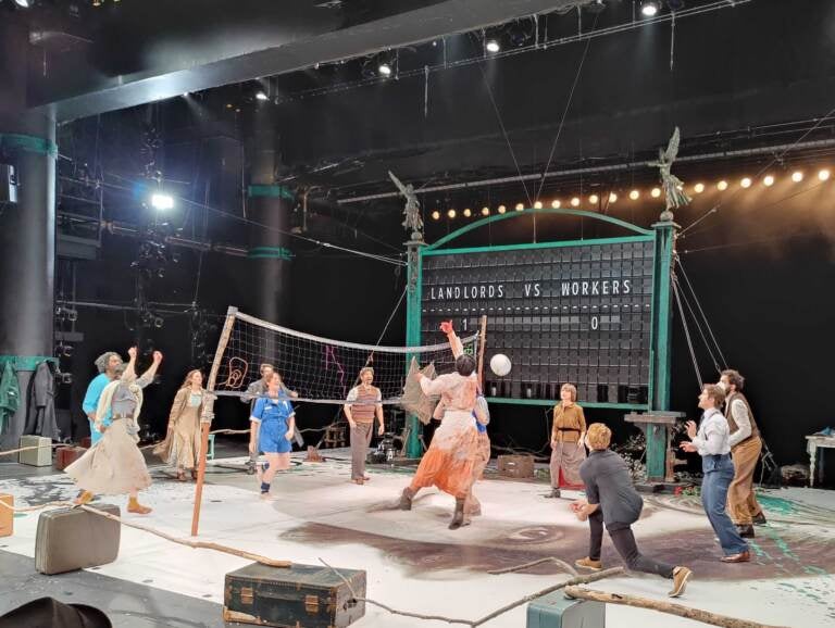 People are playing volleyball onstage in the Wilma Theater's production of 
