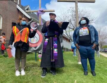Pastor Erich Kussman speaks to a crowd outside of St. Bartholomew Lutheran Church in Trenton. Community members rallied on Palm Sunday to raise awareness about possible solutions to gun violence.