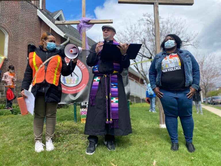 Pastor Erich Kussman speaks to a crowd outside of St. Bartholomew Lutheran Church in Trenton. Community members rallied on Palm Sunday to raise awareness about possible solutions to gun violence.