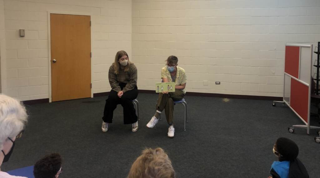 Kiley Addis and Molly Lloyd, of Victim Services of Montgomery County, reading _C is for Consent_ at Elkins Park Library (Emily Rizzo_WHYY News)