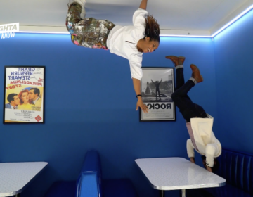 Hosts appearing to be hanging upside down in illusion diner
