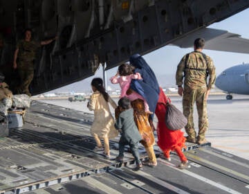 A family enters a U.S. Air Force plane in Kabul, Afghanistan, on Aug. 24, 2021. The evacuation was part of a U.S. effort to relocate Afghans to safety in the wake of the Taliban siege. But many families were separated in the process — and reuniting them has proven to be a challenge.