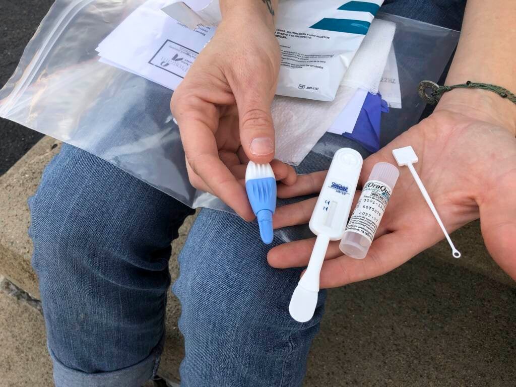 Brooke Parker displays an HIV testing kit in her hand