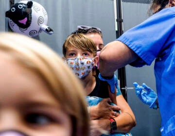 Finn Washburn, 9, receives an injection of the Pfizer-BioNTech COVID-19 vaccine in San Jose, Calif., in November. Now the pharmaceutical companies are seeking authorization to give kids a booster dose of the vaccine. (Noah Berger/AP)