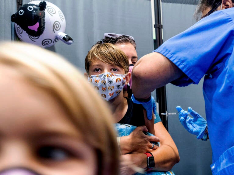 Finn Washburn, 9, receives an injection of the Pfizer-BioNTech COVID-19 vaccine in San Jose, Calif., in November. Now the pharmaceutical companies are seeking authorization to give kids a booster dose of the vaccine. (Noah Berger/AP)