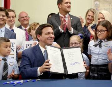 Florida Gov. Ron DeSantis displays the signed Parental Rights in Education, the so-called 