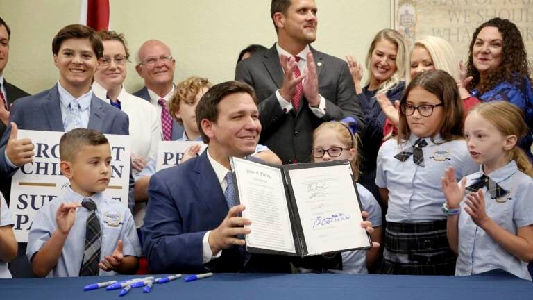 Florida Gov. Ron DeSantis displays the signed Parental Rights in Education, the so-called 
