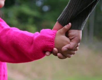 Mother and daughter holding hands