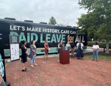 Delaware state Sen. Sarah McBride (at podium) and Dawn Huckelbridge of Paid Leave for All (in maroon dress) were staunch advocates of the measure. (Cris Barrish/WHYY)