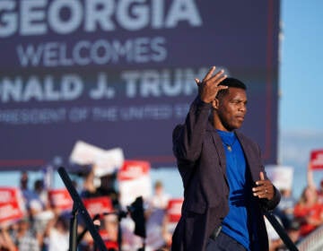 Republican Senate candidate Herschel Walker walks off the stage during a rally