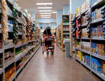 A shopper walks through a grocery store in Washington, D.C, on March 13. Surging inflation poses a particular challenge for working-class families, impacting the cost of basic necessities such as groceries. (Stefani Reynolds/AFP via Getty Images)
