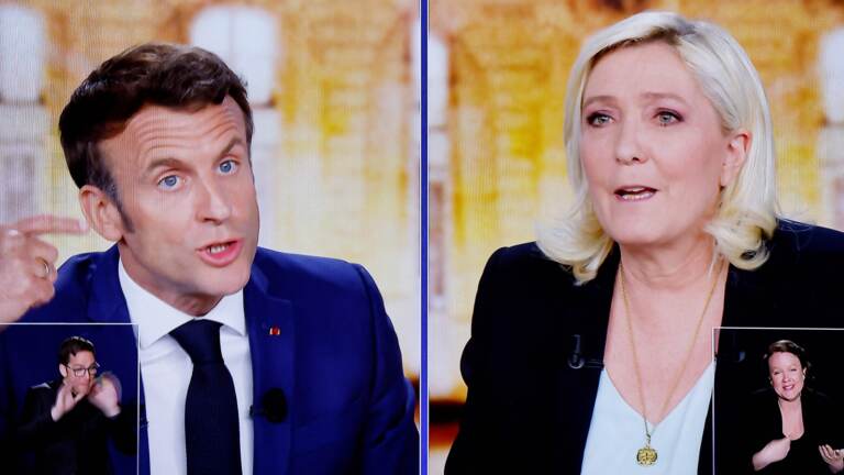 A wide gulf exists between the policies of French President Emmanuel Macron and far-right candidate Marine Le Pen. The two face off Sunday, in the second round of France's national election. (Ludovic Marin/AFP via Getty Images)