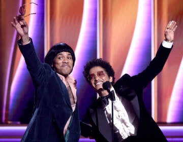 Anderson Paak (left) and Bruno Mars accept the Record of the Year award at the Grammys