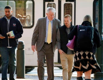John Dougherty (center) walks to the federal courthouse