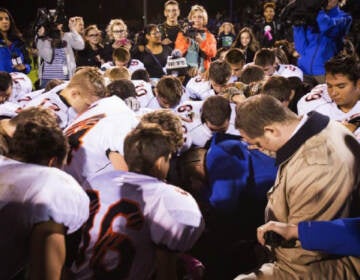The parties included this image, of Coach Kennedy praying with a crowd after the homecoming game, in their joint appendix submitted to the Supreme Court
(Court Filings)
