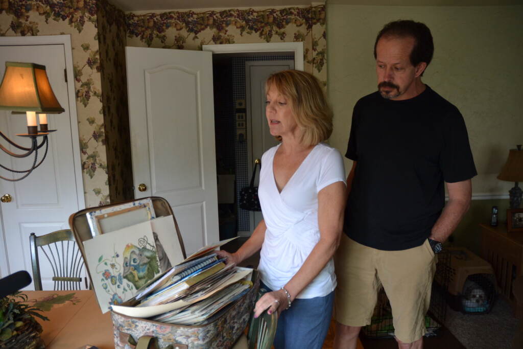 Martha and Paul Stringer stand near a box of their daughter Kim’s art