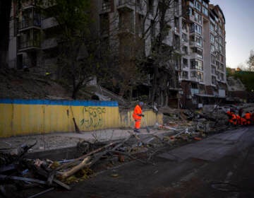 Clean-up crews work at the explosion site in Kyiv, Ukraine on Friday, April 29, 2022. Russia struck the Ukrainian capital of Kyiv shortly after a meeting between President Volodymyr Zelenskyy and U.N. Secretary-General António Guterres on Thursday evening.