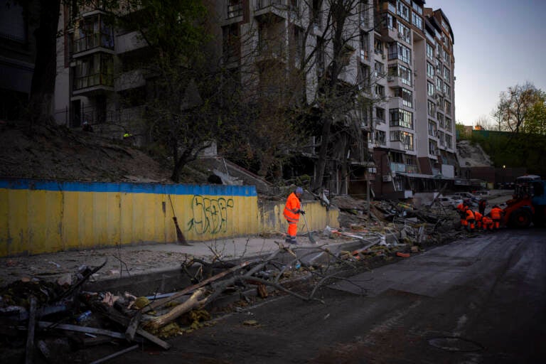 Clean-up crews work at the explosion site in Kyiv, Ukraine on Friday, April 29, 2022. Russia struck the Ukrainian capital of Kyiv shortly after a meeting between President Volodymyr Zelenskyy and U.N. Secretary-General António Guterres on Thursday evening.