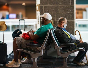 Travelers sit in a waiting area at Rhode Island T.F. Green International Airport