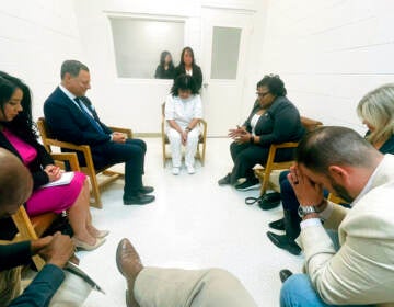 In this April 6, 2022 photo provided by Texas state Rep. Jeff Leach, Texas death row inmate Melissa Lucio, dressed in white, leads a group of seven Texas lawmakers in prayer in a room at the Mountain View Unit in Gatesville, Texas.