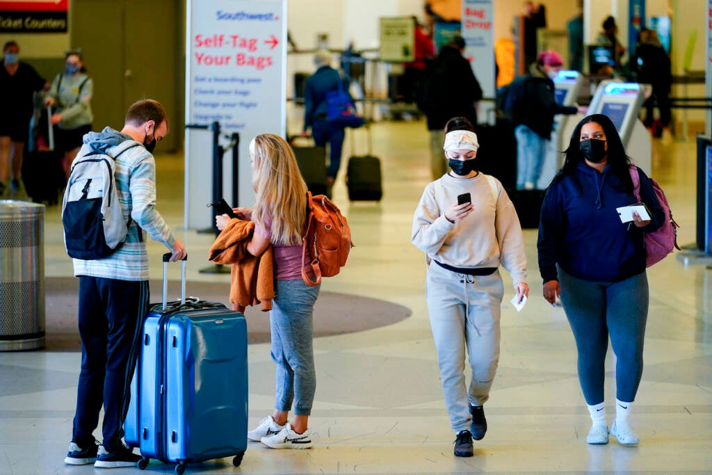 Travelers wearing face masks at PHL Airport