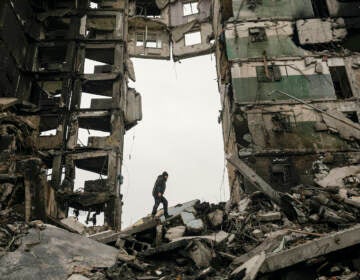 A resident looks for belongings in an apartment building destroyed during fighting between Ukrainian and Russian force