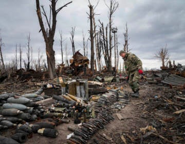 An interior ministry sapper collects unexploded shells, grenades and other devices in Hostomel