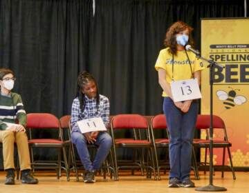 (L to R) First place finisher Jeremy Landau, second place finisher Eyianna Dunn, and third place finisher Tallulah Green Hull on stage in the final round of the WHYY-Billy Penn Regional Spelling Bee on March 26 at Penn Alexander School.