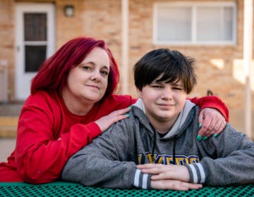 Stacey Whitford sits with her son outside