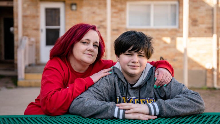 Stacey Whitford sits with her son outside